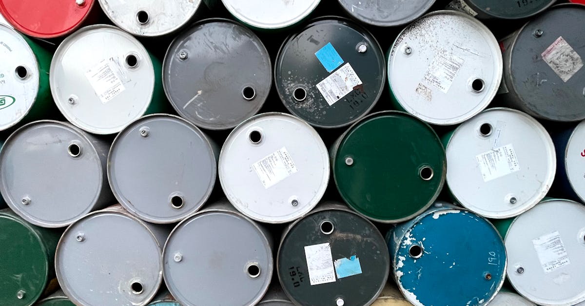 Close-up of colorful oil barrels stacked outdoors in Mandalay, Myanmar.
